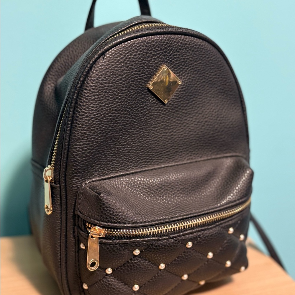 Chic Black Leather Backpack with Gold Accents